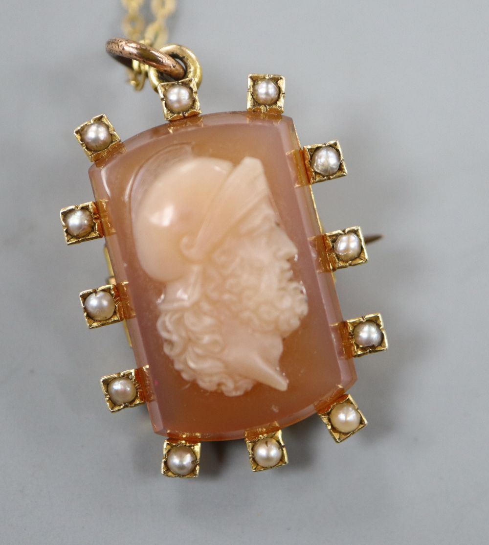 A late Victorian yellow metal and split pearl mounted hardstone cameo brooch,
